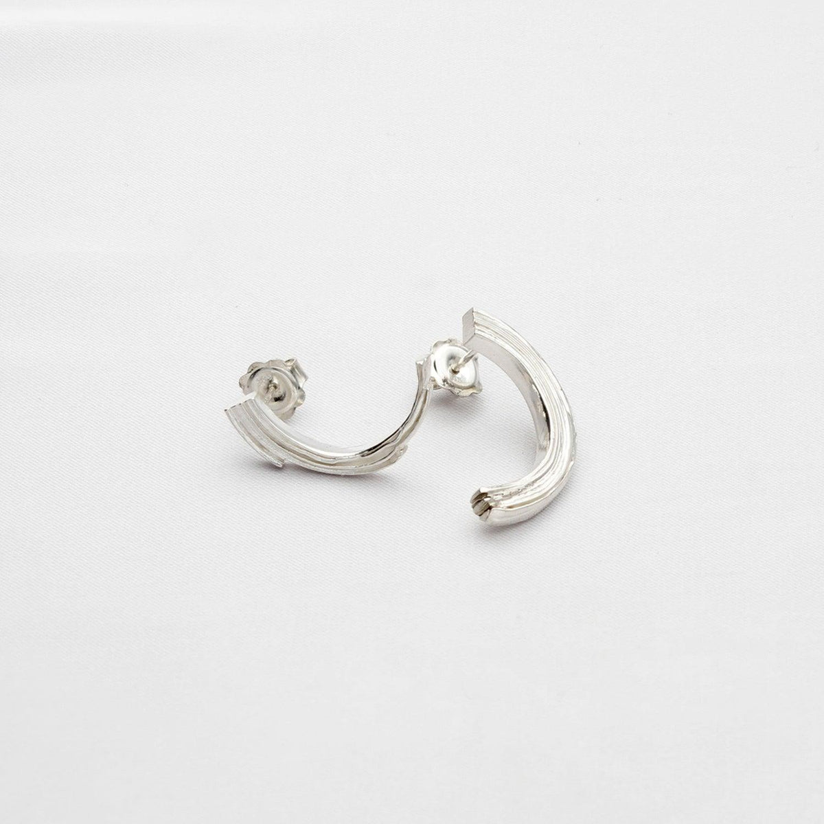 Brushstroke earrings, sterling silver — fluid line inspired by a single sweep of paint — Clustdlysau Arian