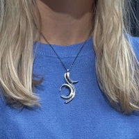 Brushstroke pendant in black oxidised silver with black diamonds, shown on model