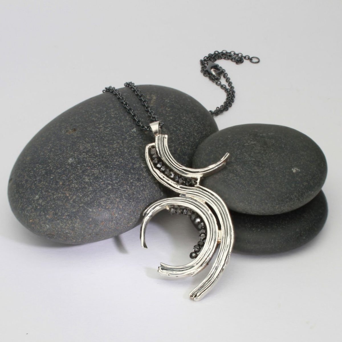 Brushstroke pendant in black oxidised silver with black diamonds, front view