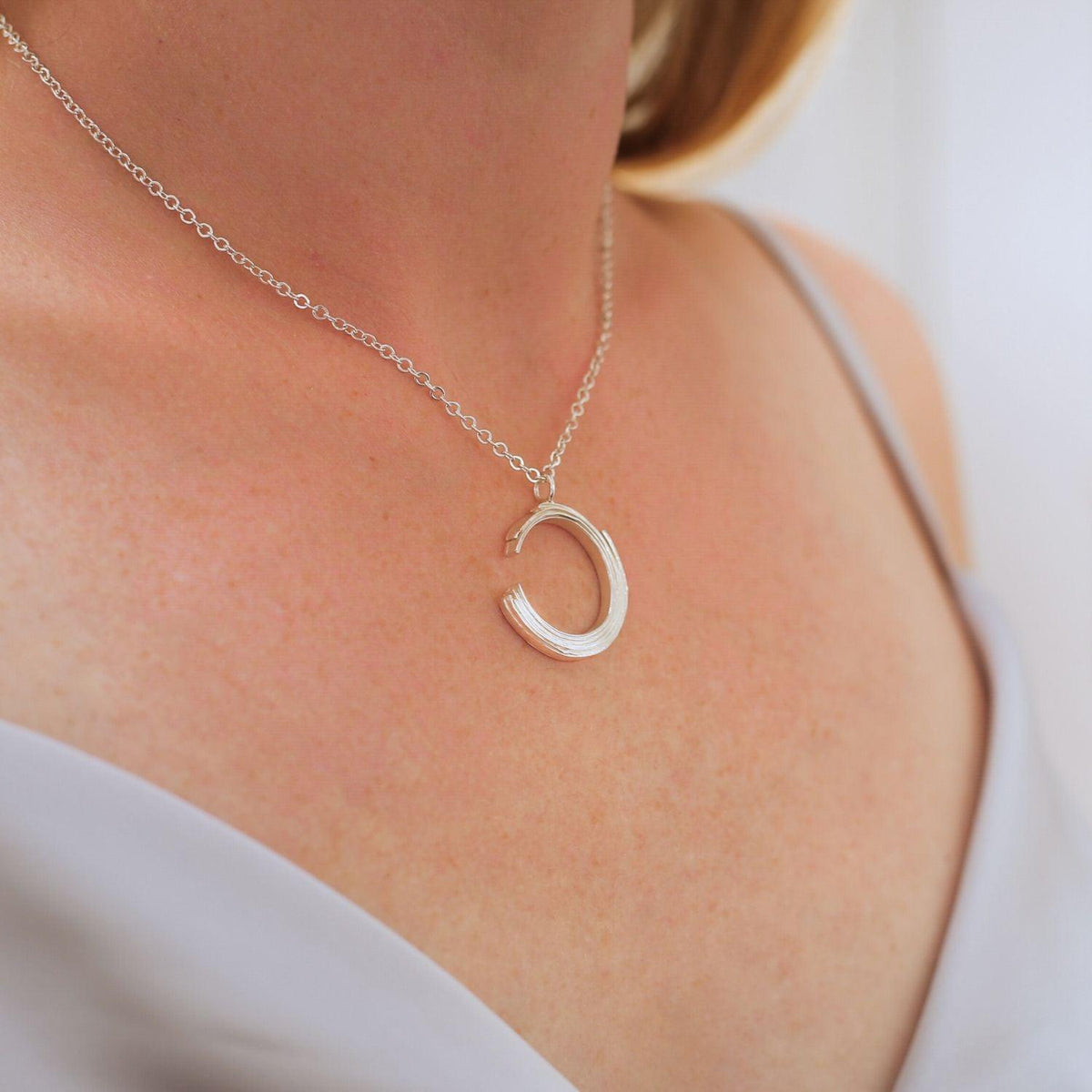 Close-up of the Brushstroke pendant's fluid line — Mwclis Arian