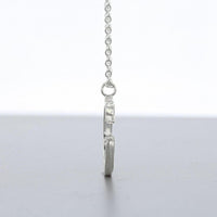 Brushstroke pendant hanging on its chain — Mwclis Arian