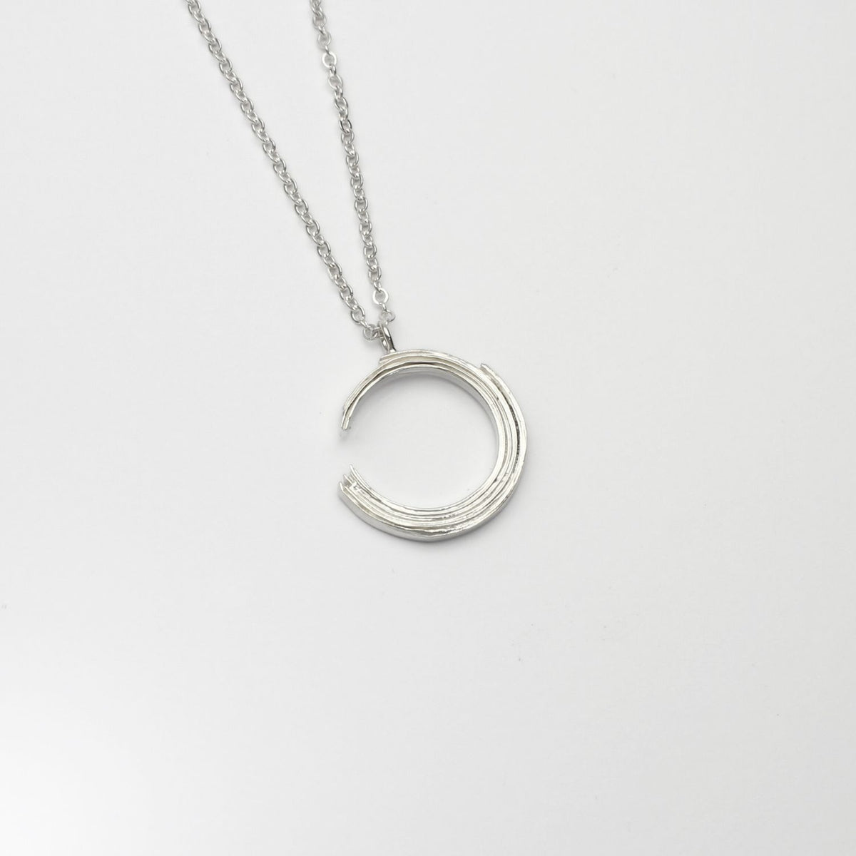 Brushstroke small sterling silver pendant, front view