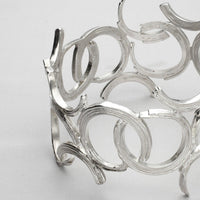 Close-up on the fluid line of the Brushstroke bangle, echoing an artist's gesture — Breichled Arian