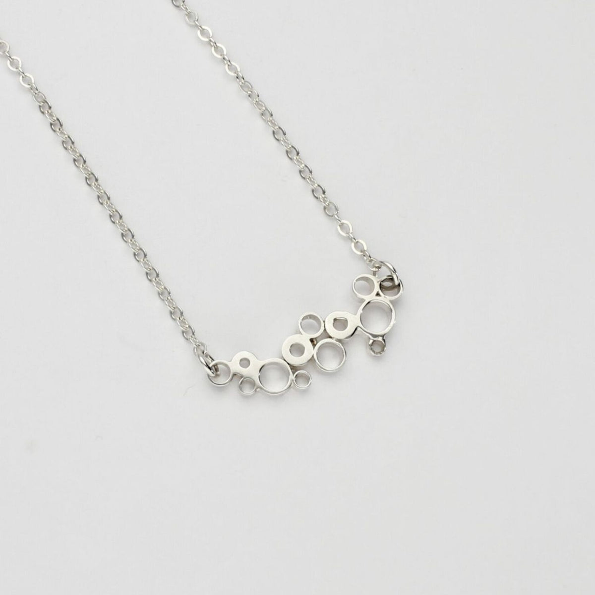 Bubbles curved pendant, sterling silver — fluid shape inspired by rising champagne bubbles — Mwclis Arian