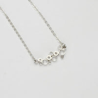 Bubbles curved pendant, sterling silver — fluid shape inspired by rising champagne bubbles — Mwclis Arian