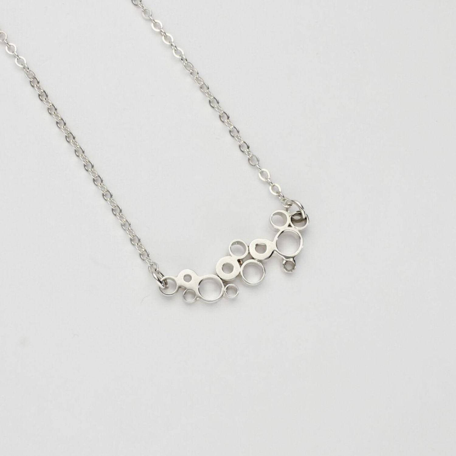 Bubbles curved pendant, sterling silver — fluid shape inspired by rising champagne bubbles — Mwclis Arian