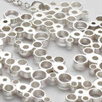 Close-up on the clustered circles of the Bubbles large pendant, echoing bubbles in a glass — Mwclis Arian