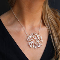Model wearing the Bubbles large pendant, celebration-inspired design — Mwclis Arian