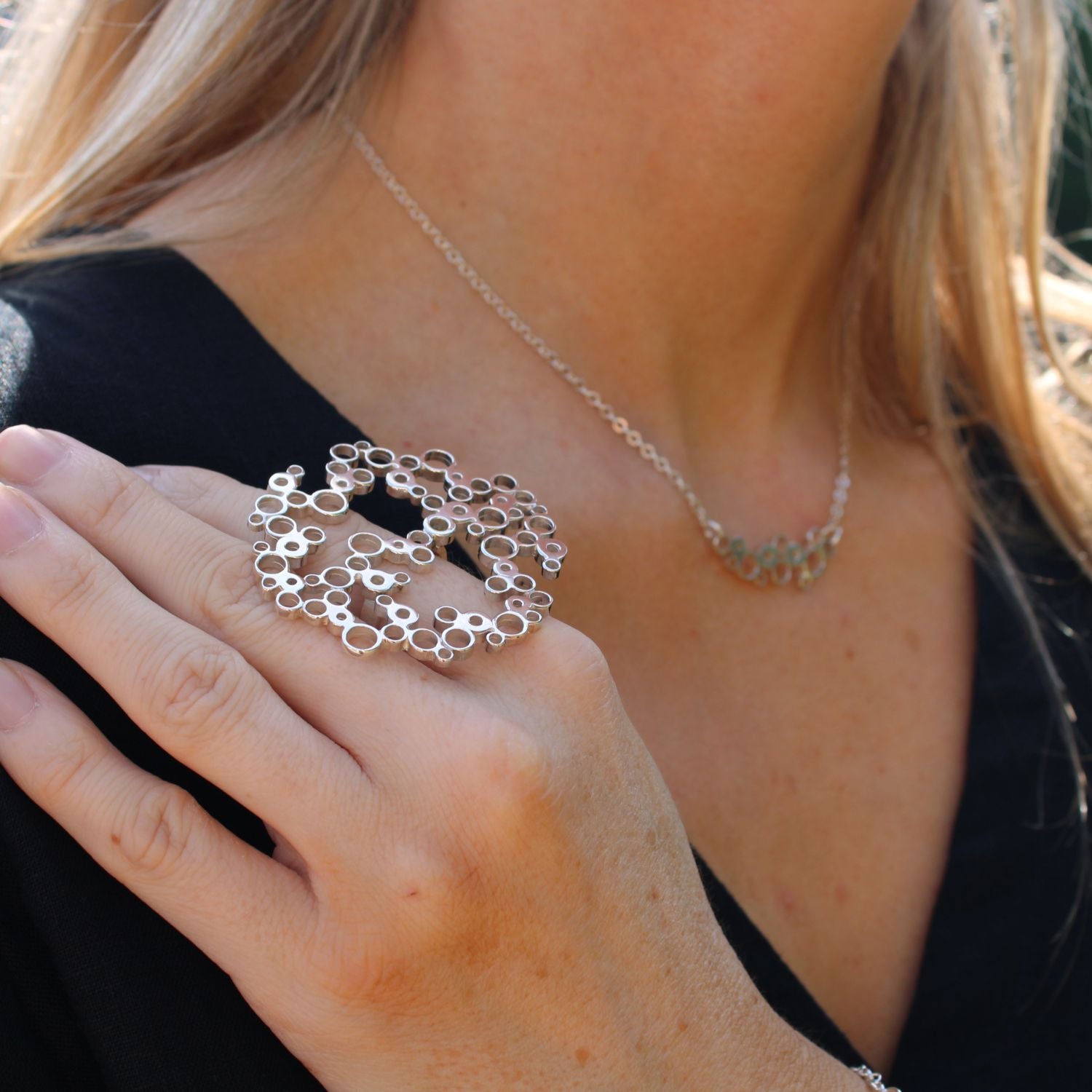 Model pairing the Bubbles large ring with the curved pendant, celebration-themed — Modrwy Arian