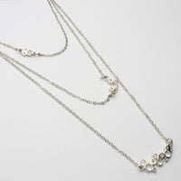 Close-up on the Bubbles layered necklace's clustered circles, echoing bubbles in a glass — Mwclis Arian