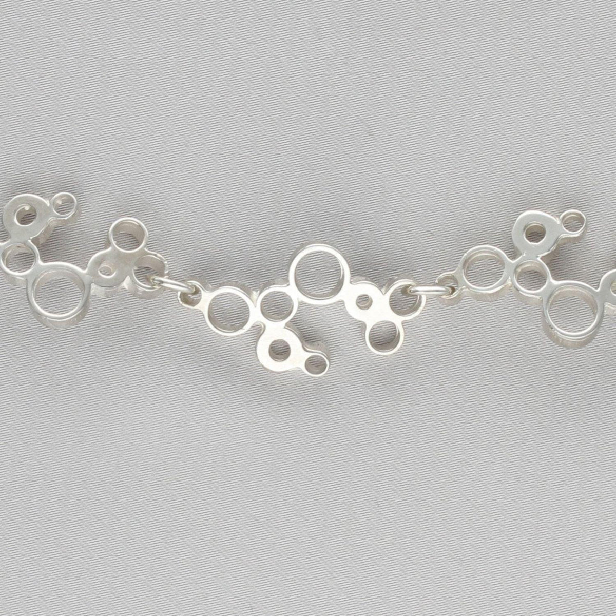 Side angle of the Bubbles linked bracelet, celebration-inspired design — Breichled Arian