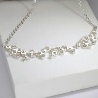Close-up of the diamonds set within the Bubbles necklace's clustered circles — Mwclis Arian