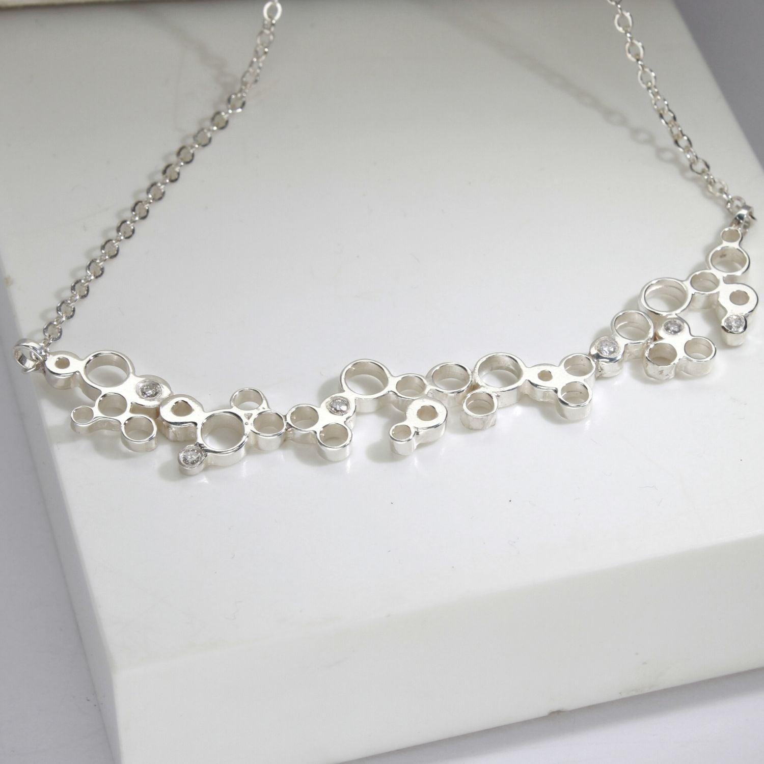 Close-up of the diamonds set within the Bubbles necklace's clustered circles — Mwclis Arian