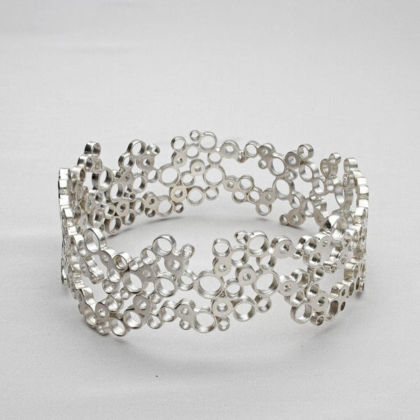 Bubbles bangle, sterling silver — clustered circles inspired by rising champagne bubbles, front view — Breichled Arian