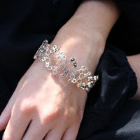 Model wearing the Bubbles bangle, front angle, celebration-themed — Breichled Arian