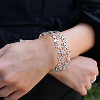 Model wearing the Bubbles bangle, side angle, effervescent design — Breichled Arian