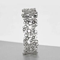 Bubbles bangle turned to show its profile, celebration-inspired — Breichled Arian