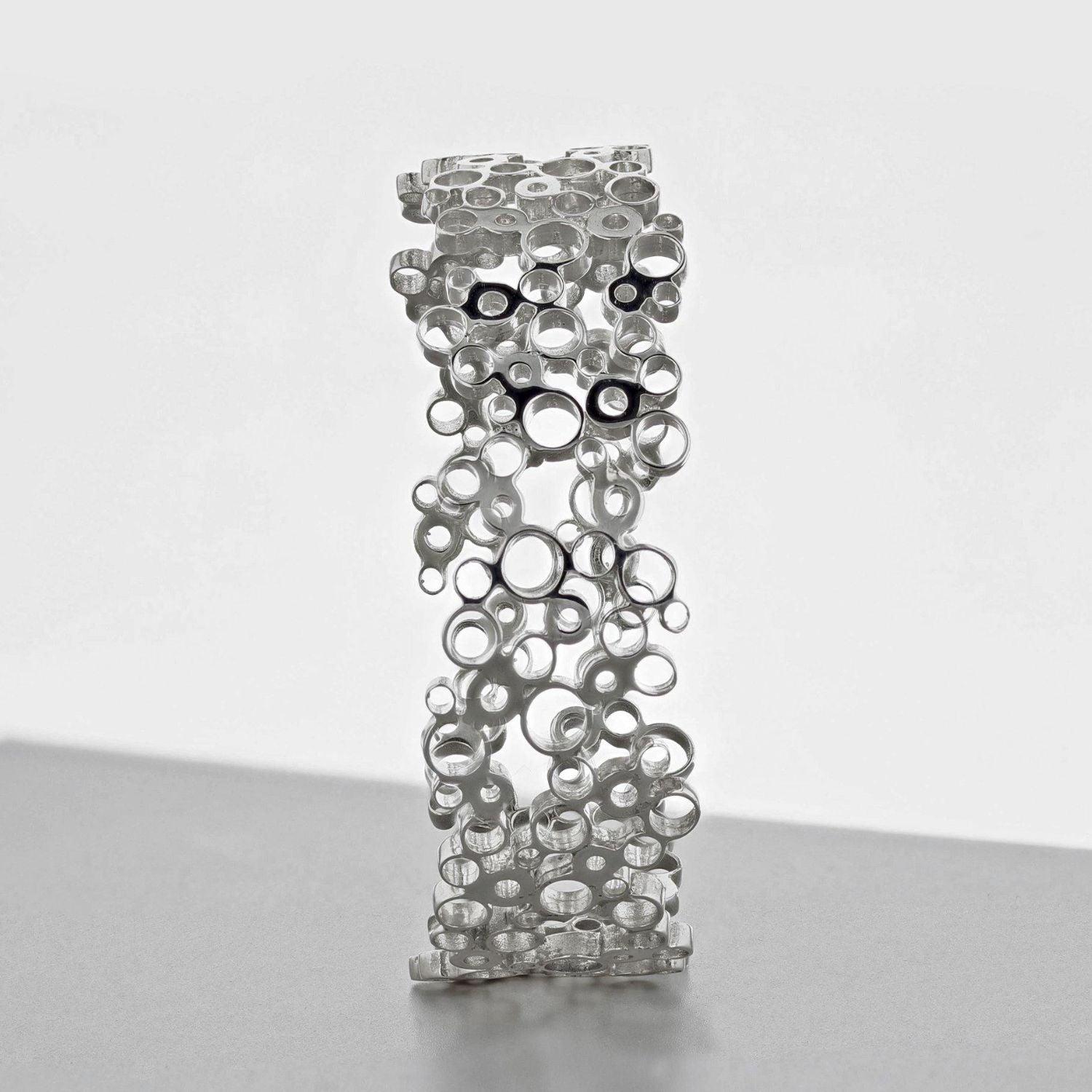 Bubbles bangle turned to show its profile, celebration-inspired — Breichled Arian