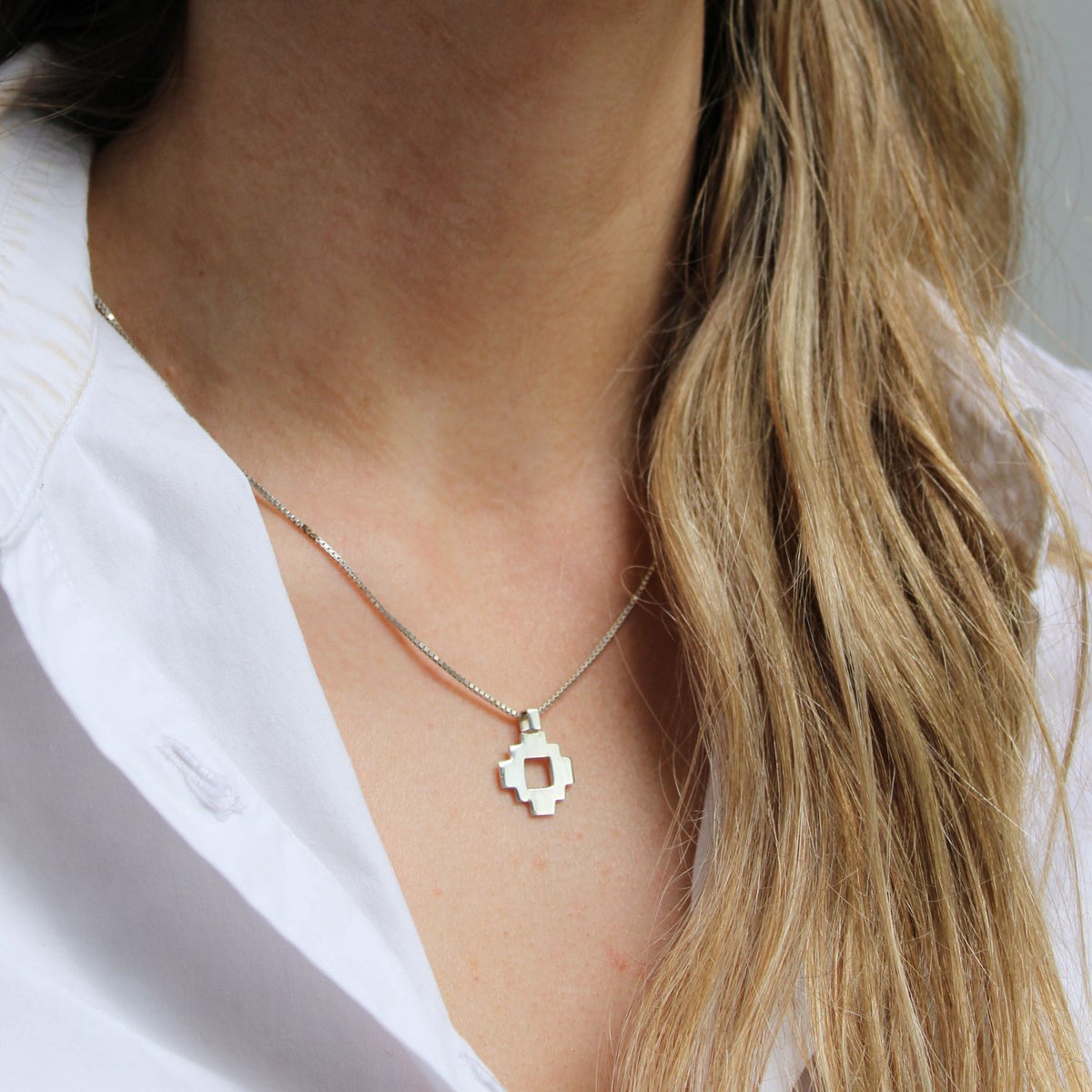 Model wearing the Caernarfon hatch pendant, rooted in hiraeth — Mwclis Arian