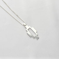 Caernarfon long pendant, sterling silver — the Welsh weave stretched into a linear form — Mwclis Arian