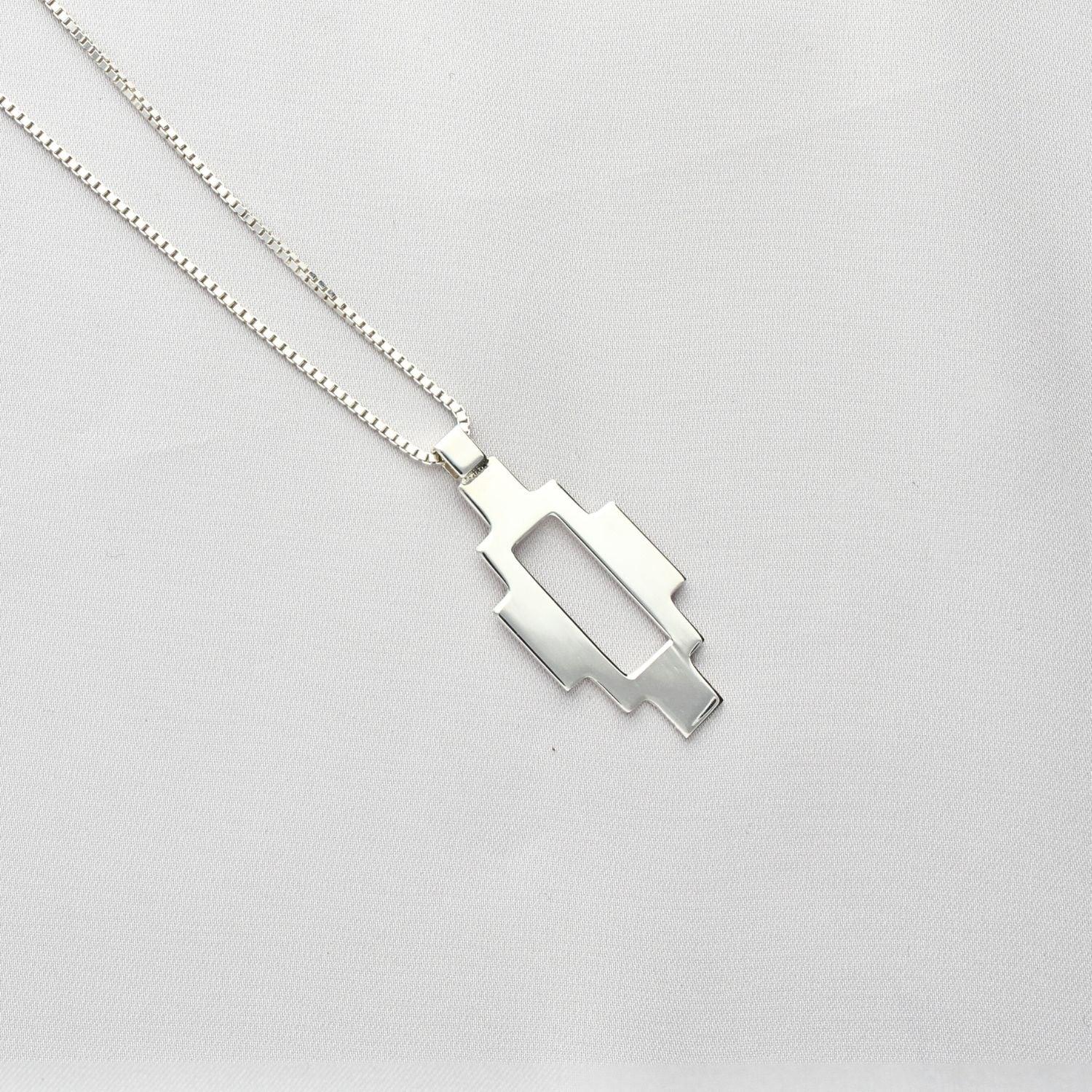 Caernarfon long pendant, sterling silver — the Welsh weave stretched into a linear form — Mwclis Arian