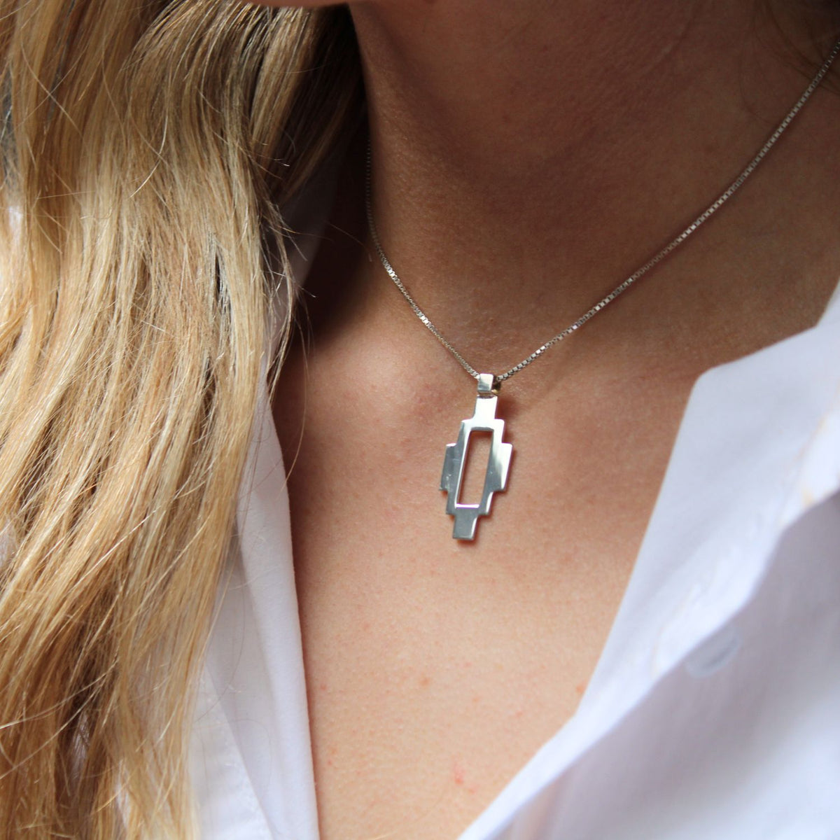 Model wearing the Caernarfon long pendant, rooted in hiraeth — Mwclis Arian