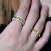 Contemporary Welsh gold jewellery designed and made in Wales and inspired by the Welsh landscape. These rings in gold are silver are handcrafted and perfect for stacking as shown on model.