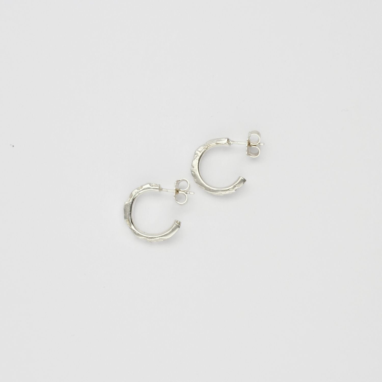 Carved sterling silver hoop earrings, top view
