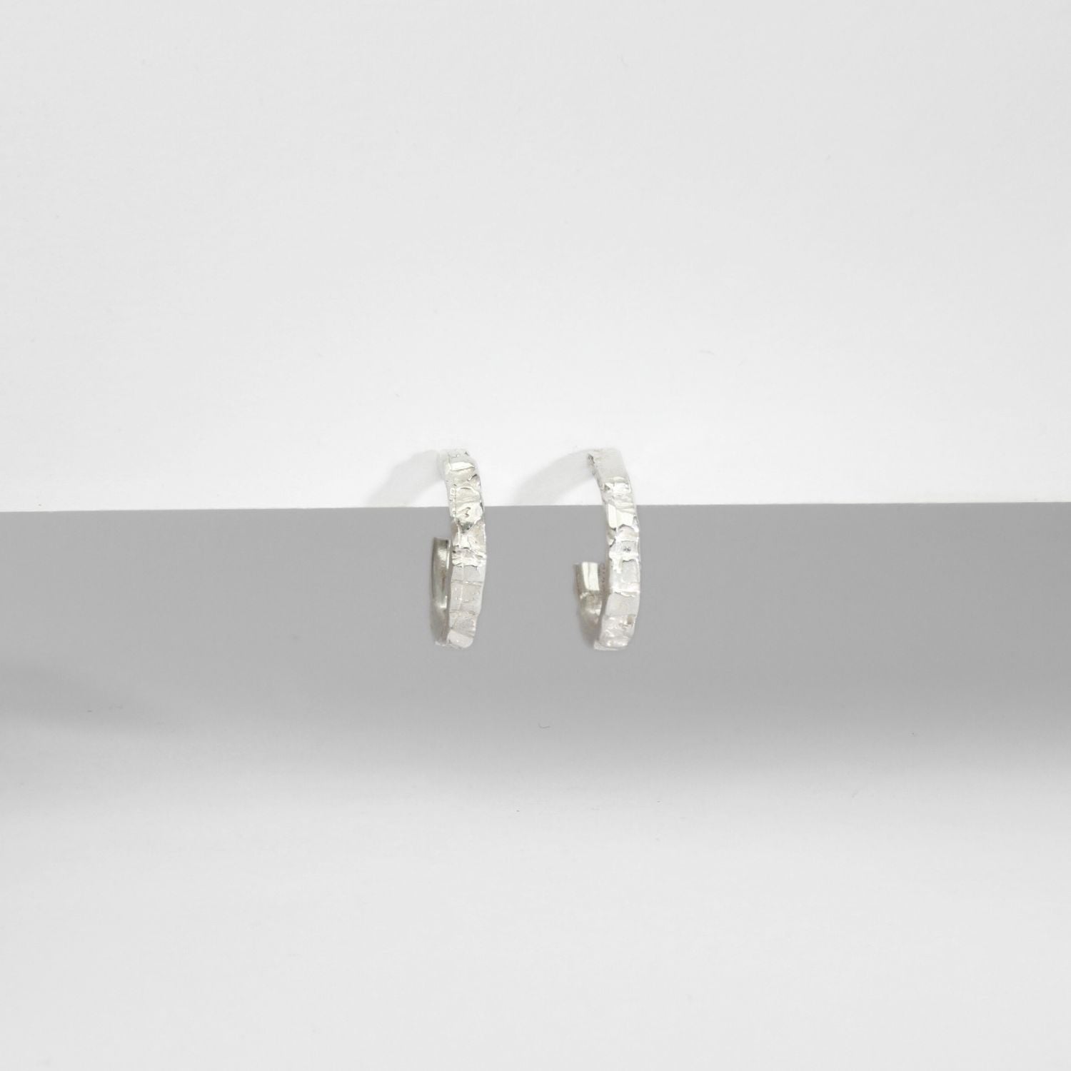 Carved sterling silver hoop earrings, nature-inspired texture