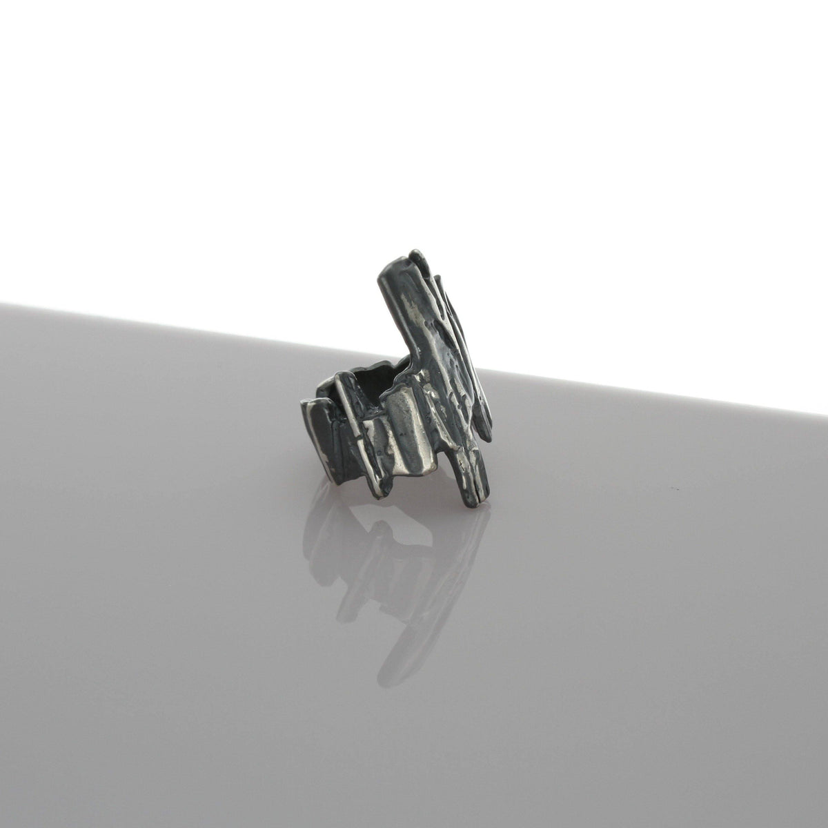 Carved long ring in sterling silver and black oxidised silver, inspired by Welsh slate and anthracite coal