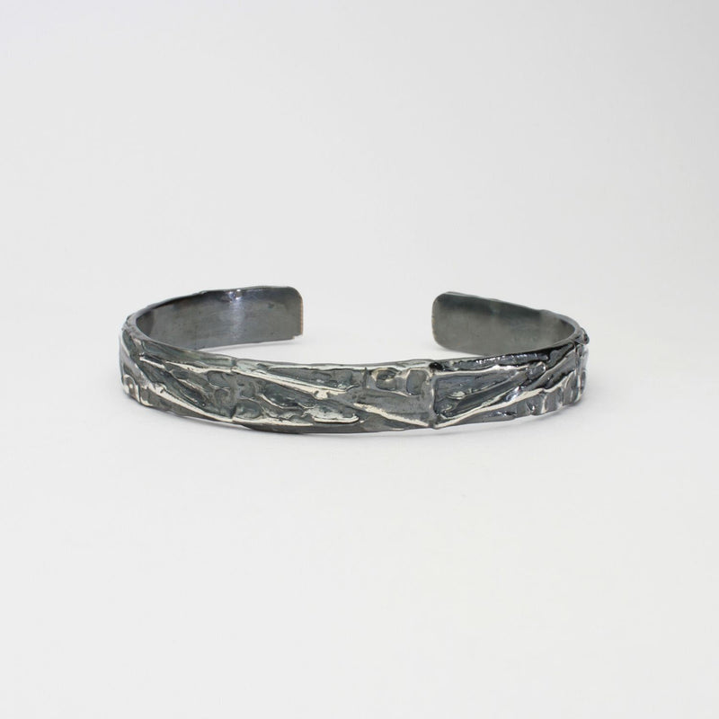 Contemporary Welsh silver jewellery. Inspired by the beautiful landscape of Wales especially slate and coal. This torque cuff bangle is designed and handmade in Wales. Suitable for men or women.