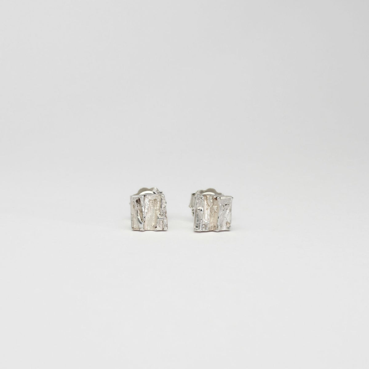 Contemporary Welsh silver jewellery. Inspired by the beautiful landscape of Wales.  These small textured square stud earrings are designed and handmade in Wales