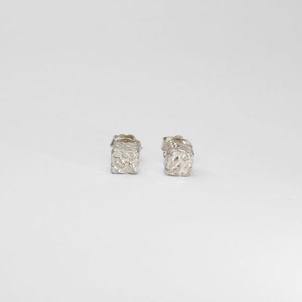 Cube stud earrings, sterling silver — covered in fragments of Mari's own handwriting — Clustdlysau Arian