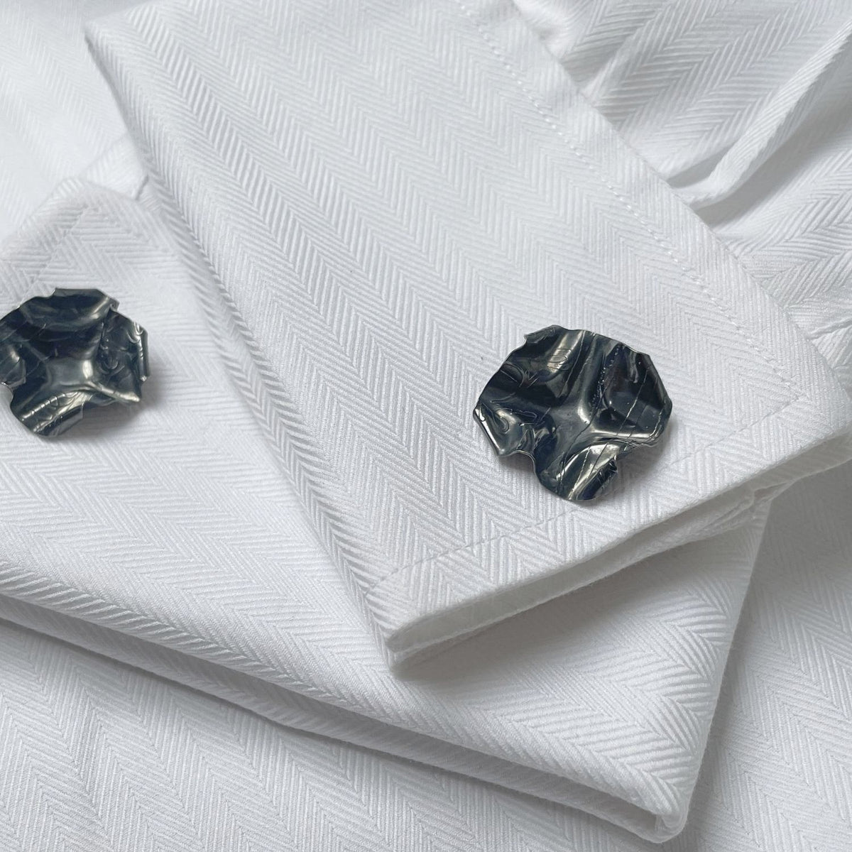 Decorative Concepts cufflinks in black oxidised silver, shown on shirt