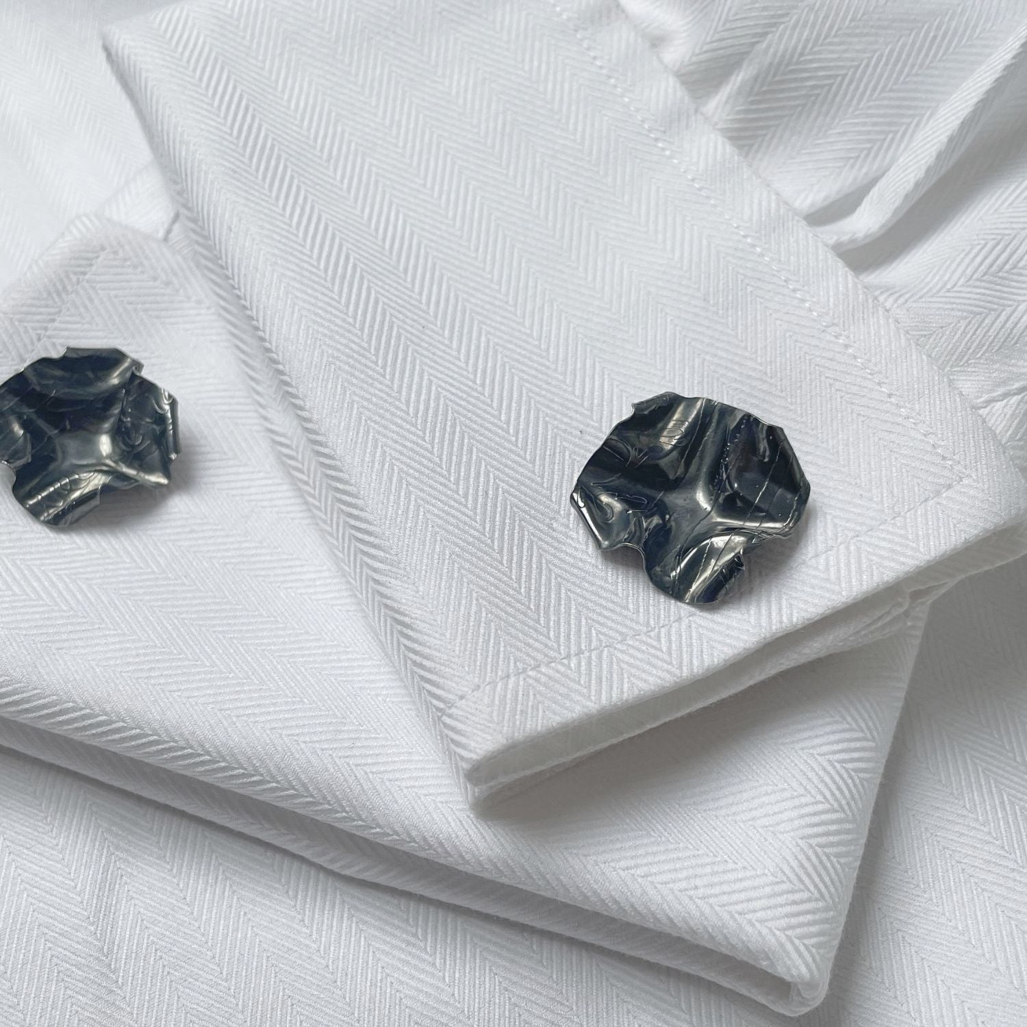 Decorative Concepts cufflinks in black oxidised silver, shown on shirt