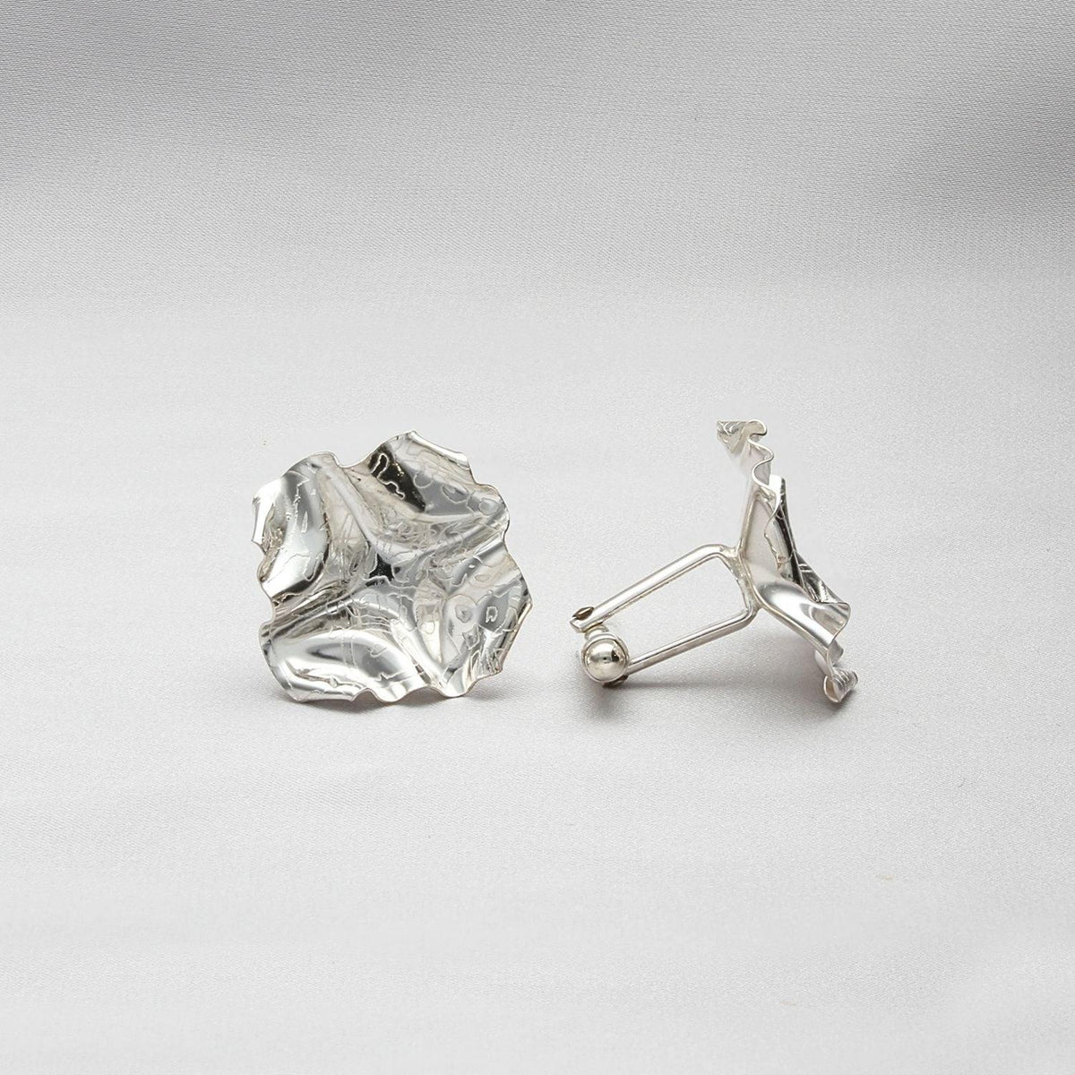 Decorative Concepts cufflinks, a considered mark cast in sterling silver — Botymau Coesau Arian
