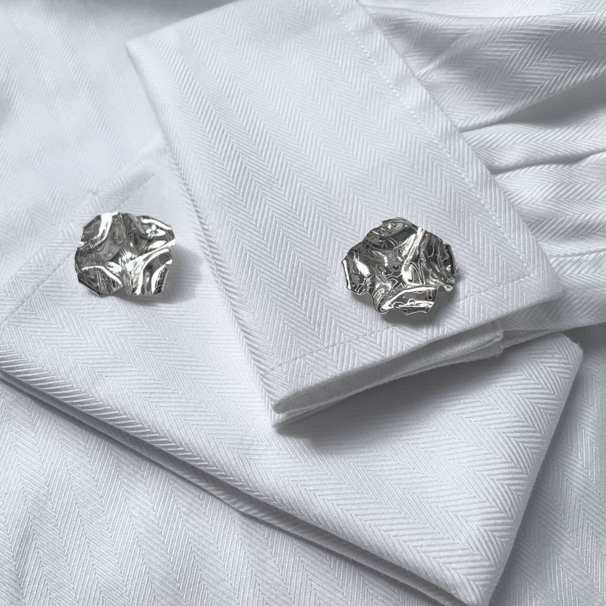 Decorative Concepts cufflinks fastened on a shirt cuff, drawn from an artist's sketchbook — Botymau Coesau Arian