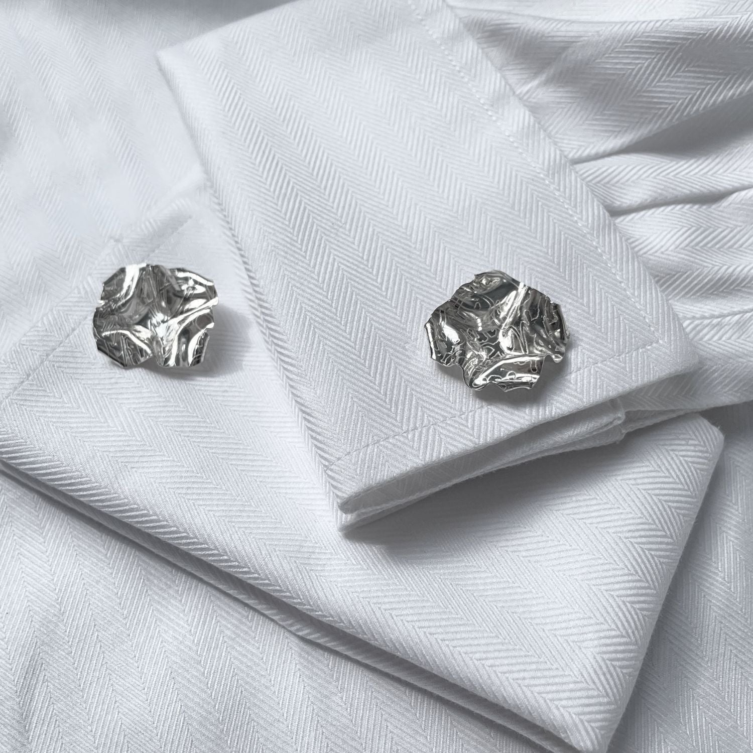 Decorative Concepts cufflinks fastened on a shirt cuff, drawn from an artist's sketchbook — Botymau Coesau Arian