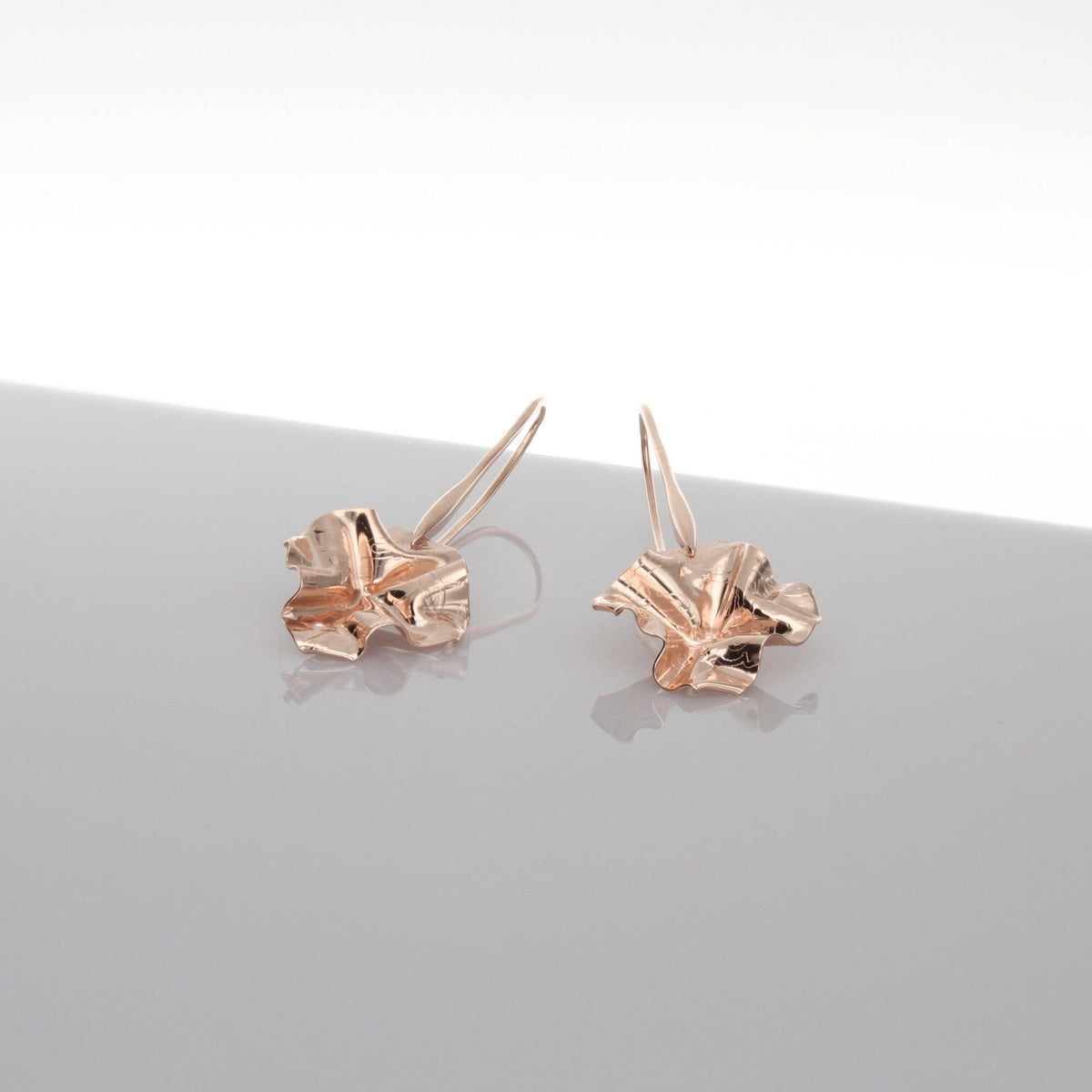 Decorative Concepts drop earrings, tracing a sketched line on paper — 18ct rose gold plated silver — Clustdlysau Arian ac Aur