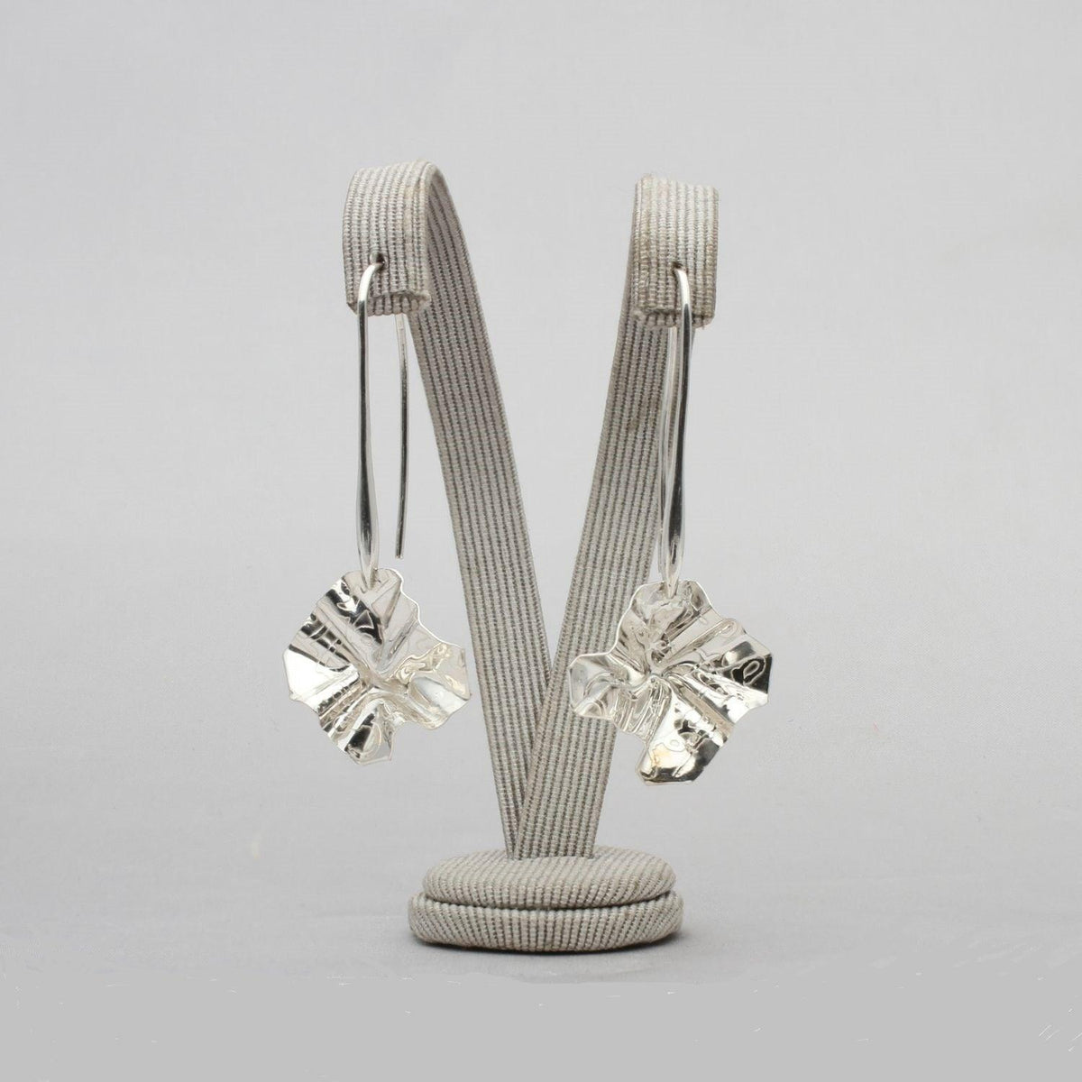 Decorative Concepts drop earrings, tracing the shape of a sketched line on paper — Clustdlysau Arian