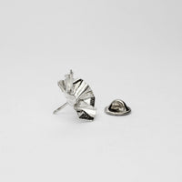 Side view of the Decorative Concepts pin, echoing a writer's pencil line