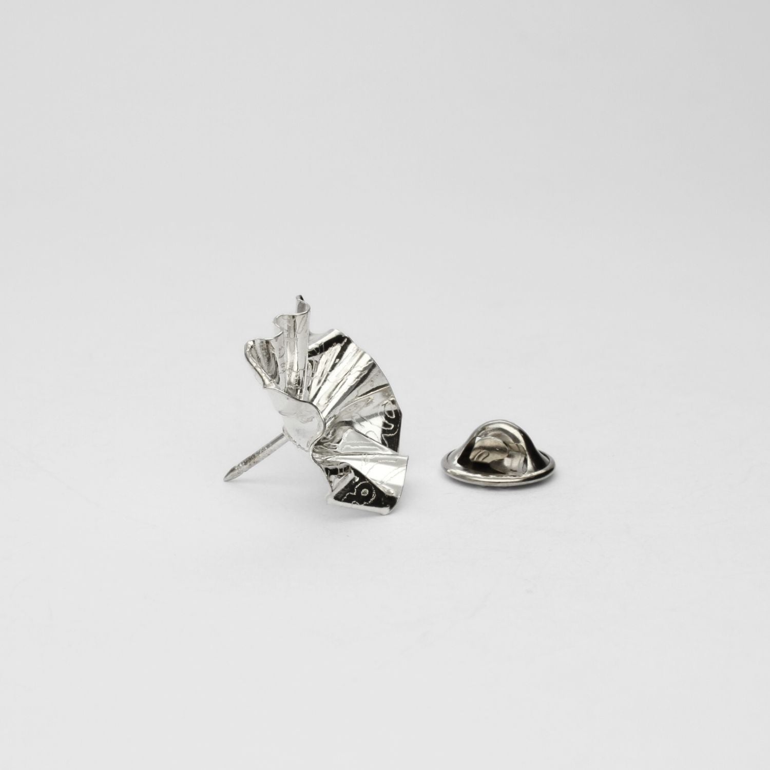 Side view of the Decorative Concepts pin, echoing a writer's pencil line