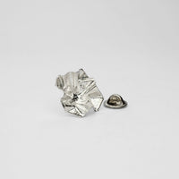 Decorative Concepts lapel pin, sterling silver — a considered mark drawn from paper