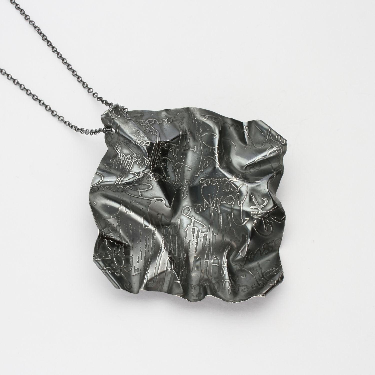 Decorative Concepts large pendant, black oxidised silver — a bold pen stroke cast in metal — Mwclis Arian