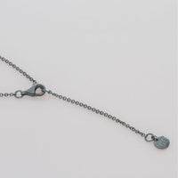 Decorative Concepts pendant on its chain, tracing a writer's notebook line — Mwclis Arian