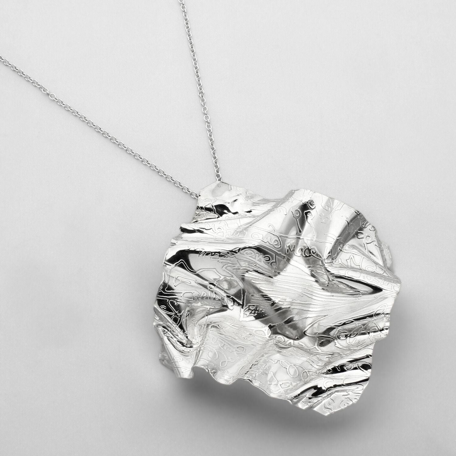 Decorative Concepts large pendant on its chain, a bold sketchbook mark — Mwclis Arian
