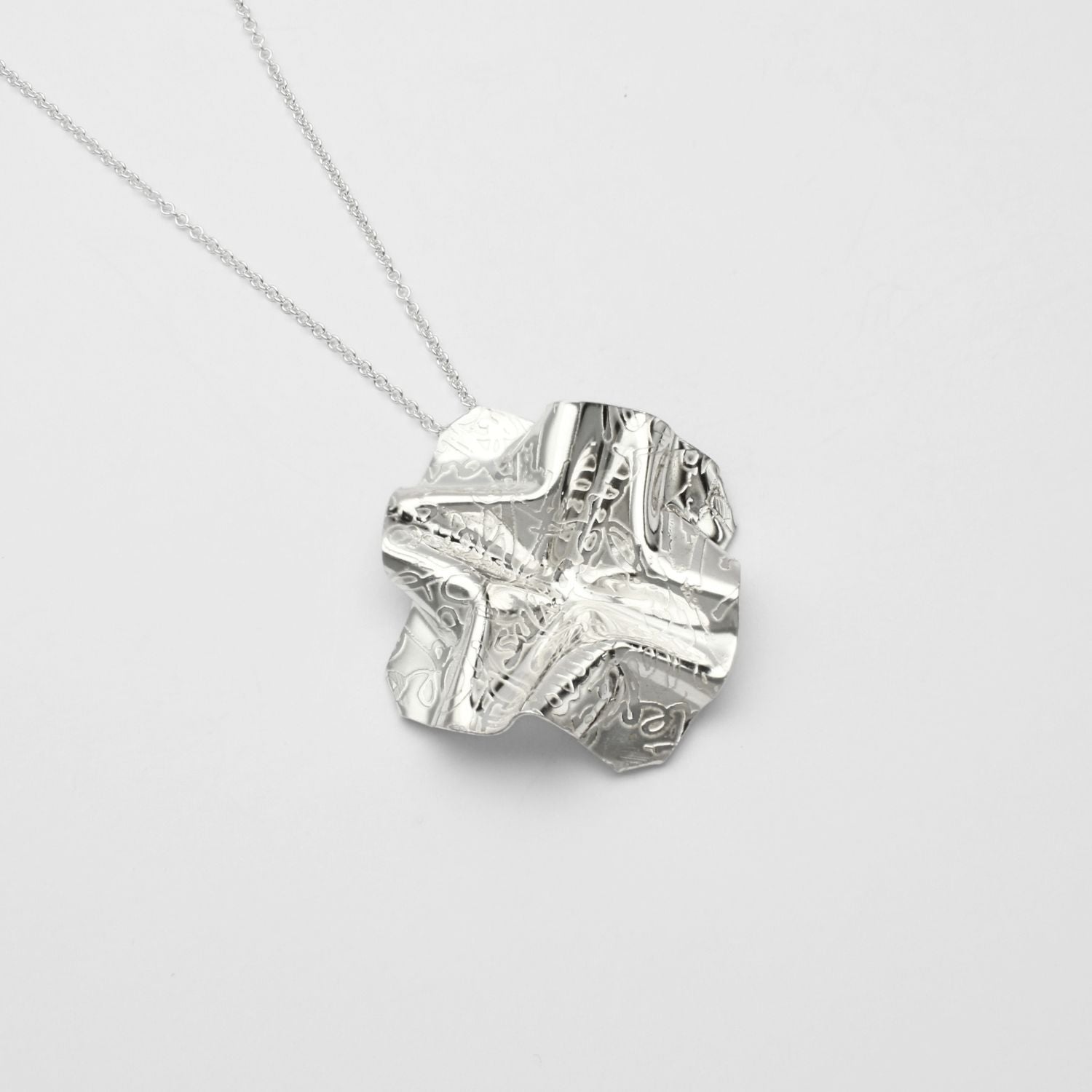 Decorative Concepts medium pendant, sterling silver — a bold pen stroke cast in metal — Mwclis Arian