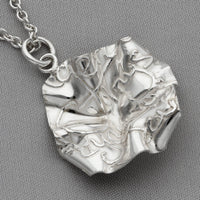 Side profile of the Decorative Concepts pendant, inspired by a page of handwriting — Mwclis Arian