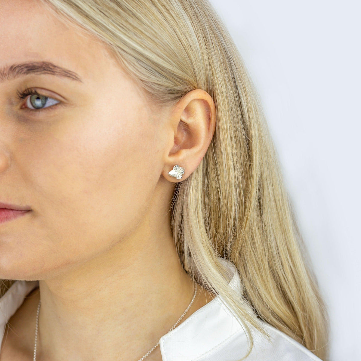 A pair of Decorative Concepts studs, inspired by a writer's shorthand — Clustdlysau Arian