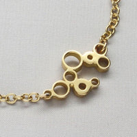 Golden Bubbles bracelet, celebration-themed design, side view — Breichled Aur